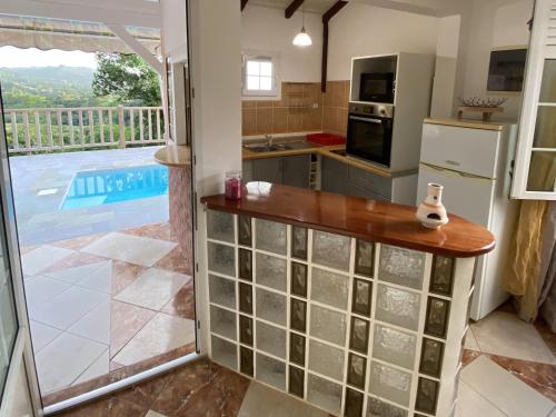 a kitchen with a view of a pool at Appartement T2 - vue campagne in Le Robert