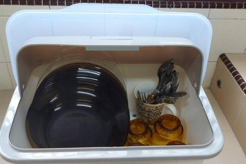a washing machine with a bowl and utensils in it at Alor Setar City Homestay in Alor Setar
