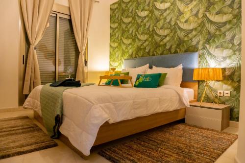 um quarto com uma cama grande e uma parede verde em La Ola Del Mar em Tânger