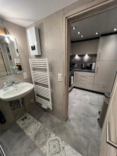 a large bathroom with a sink and a kitchen at Chalet St. Lambertus in Lambertsberg