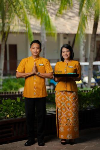 a man and a woman standing next to each other at Banyu Biru Villa in Lagoi