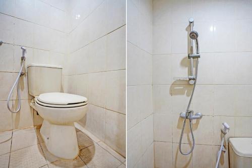 a bathroom with a toilet and a shower at OYO Life 93111 Garden Homestay 2 Merlion in Lontar