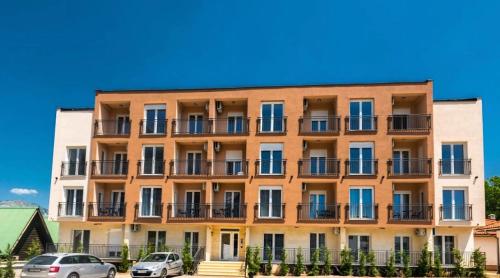 a building with cars parked in front of it at Stasa_cozy_nest in Kolašin