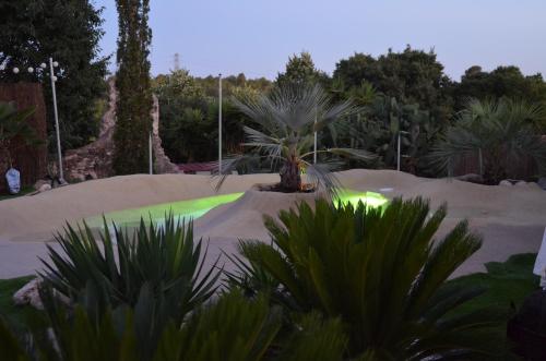 a skate park with a green glow in the sand at Peralta Villas Boutique Adults Only in Renau