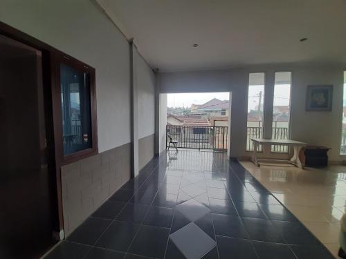 an empty hallway with a view of a building at Turu Hostel in Lampung