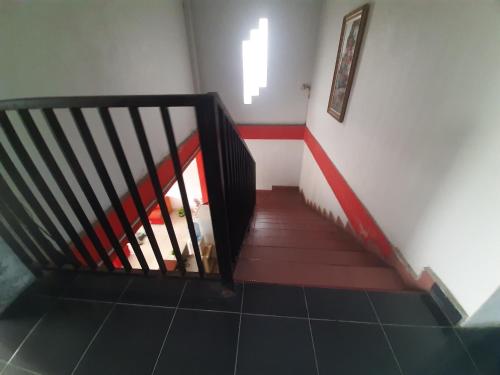 a staircase in a room with a stair case at Turu Hostel in Lampung