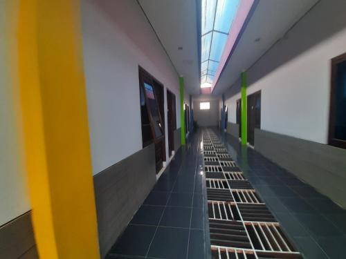 an empty hallway of a building with a ceiling at Turu Hostel in Lampung