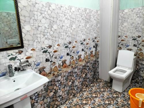 a bathroom with a sink and a toilet at Solan Regency in Solan