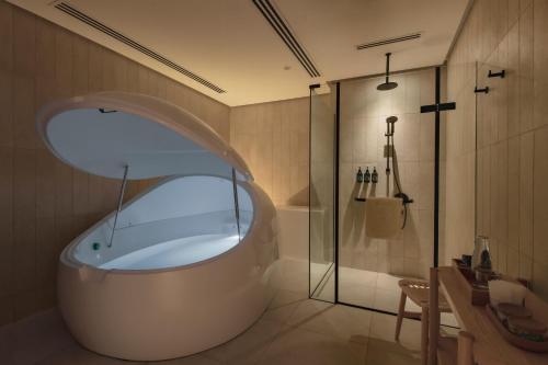 a bathroom with a tub and a shower at Else Kuala Lumpur in Kuala Lumpur
