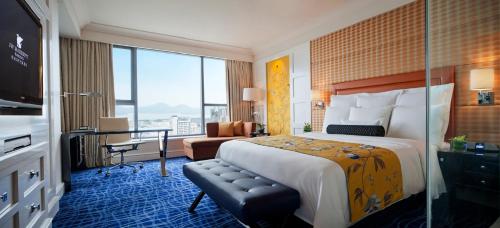 a hotel room with a large bed and a desk at JW Marriott Hotel Hangzhou in Hangzhou