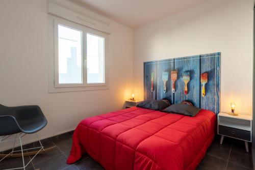 een slaapkamer met een rood bed en een raam bij ARES - Vue Mer in Le Grau-dʼAgde
