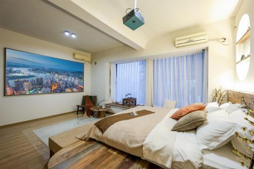 a bedroom with a large bed and a large window at Baihong Riverview Apartment-Hongya Cave in Chongqing