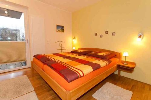 a large bed in a room with a large window at Residenz/Sommerwind in Warnemünde