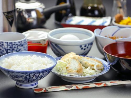 a table topped with bowls of food on a table at Yukikan in Yuki