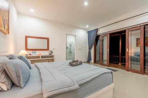 Кровать или кровати в номере Pini Sentana Village Nusa Penida