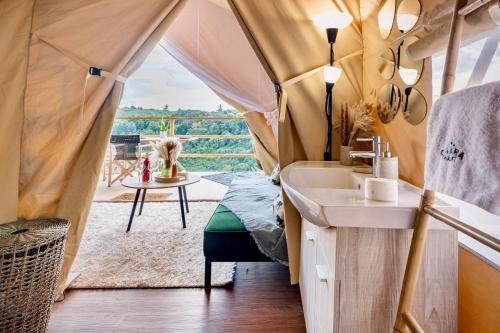 a bathroom with a sink in a tent with a view at Civara Chalet - Private Glamping in nature with Jakuzzi in Tsivarás