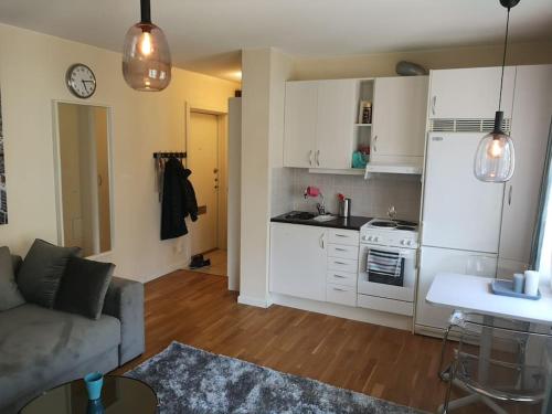 a kitchen and living room with a white refrigerator at Norrköping City in Norrköping