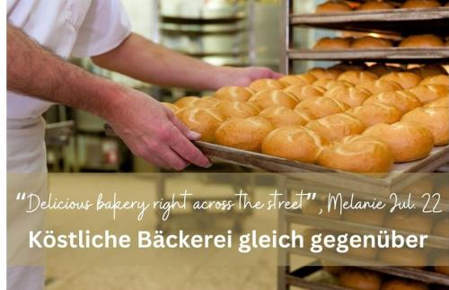 a baker is holding a tray of bread in a bakery at Living-in-History: Historischer Charme und Design in Dudeldorf
