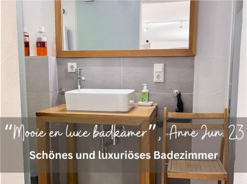 a bathroom with a sink and a mirror at Living-in-History: Historischer Charme und Design in Dudeldorf