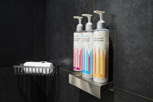 a group of three oxygen bottles on a shelf in a bathroom at Hôtel Alt Québec in Quebec City