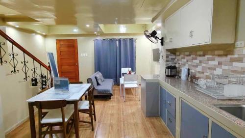 a kitchen with a table and chairs in a room at Ormoc City Gate 2 Apartment in Ormoc