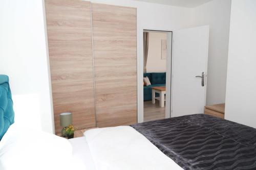 a bedroom with a large wooden closet with a bed at HILLSIDE Apartments in Žabljak