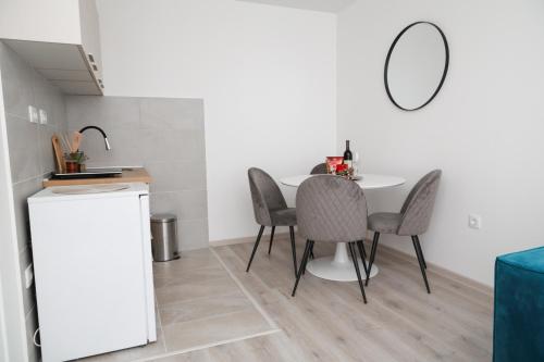 a kitchen with a table and chairs and a mirror at HILLSIDE Apartments in Žabljak