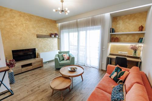 a living room with a couch and a tv at AnnaG apart in Athens