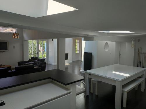 un salon avec une table et un canapé dans l'établissement Spacieuse villa avec jardin Deauville centre, à Deauville