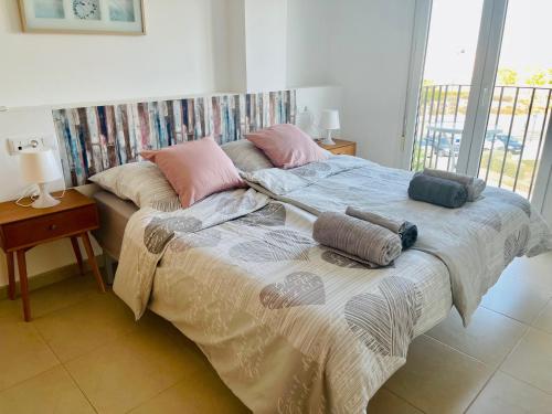 a bed with pillows on it in a bedroom at Apartment Lucy Hacienda Riquelme Golf resort in Murcia