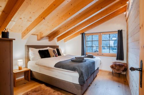 a bedroom with a bed and a window at Ski in & out Chalet Marmo in Zermatt in Zermatt