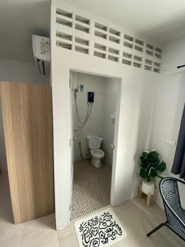 a bathroom with a toilet and a bunk bed at 84 Bar & Guest House Room 5 in Ban Huai Luk (1)