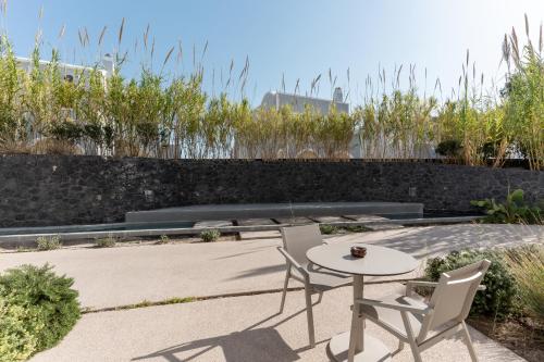 a patio with two chairs and a table at Orama Hotel & Spa in Fira