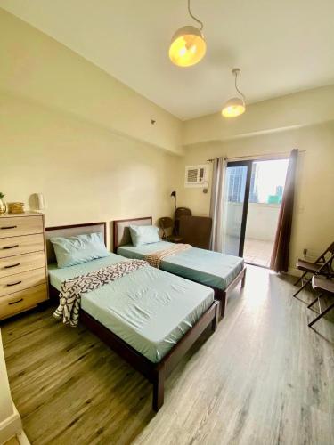 a bedroom with two beds and a dresser and a window at Studio With balcony in Carreta
