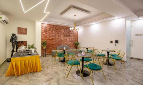 a room with tables and chairs and a brick wall at The Embassy Inn in Noida