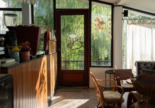 a room with a door and some chairs and windows at Ploen Pirom in Lat Krabang
