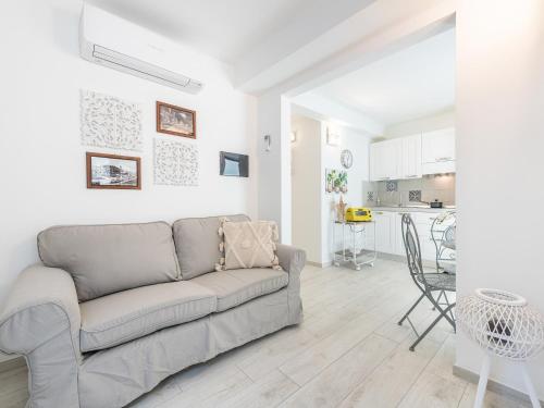 a living room with a couch and a kitchen at La Buona Stella Guesthouse - City Centre in Cagliari