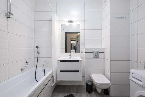 a white bathroom with a sink and a toilet at 02 Gdynia Premium - Apartament Mieszkanie dla 2os in Gdynia