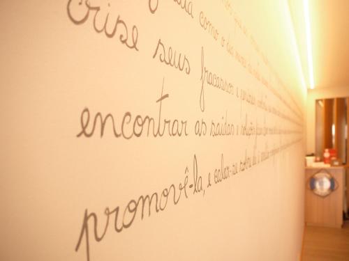 a wall with writing on the side of a room at Guest House A&z in Espinho