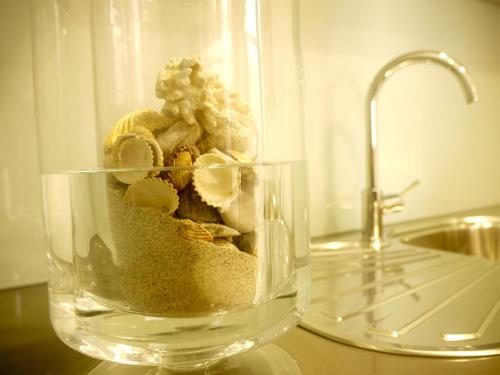 a glass vase filled with sand and banana slices at Guest House A&z in Espinho