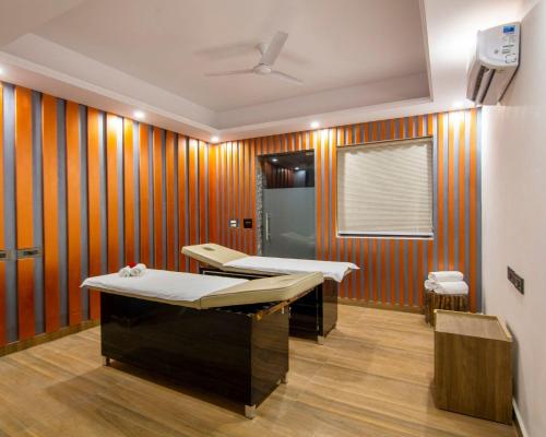 a room with two beds in it with orange stripes at The Embassy Inn in Noida