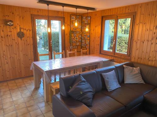 a living room with a table and a couch at Chalet Lé Fèrtin in La Tzoumaz