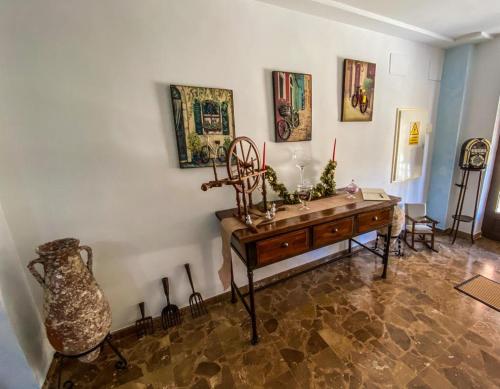 a room with a wooden table and a vase at Hostal Ca'n Pep in Sa Ràpita