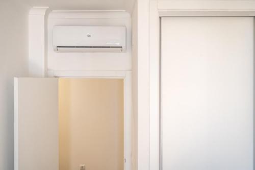 a refrigerator in a room with a window at Akisol Portalegre Charm in Ponte de Sor