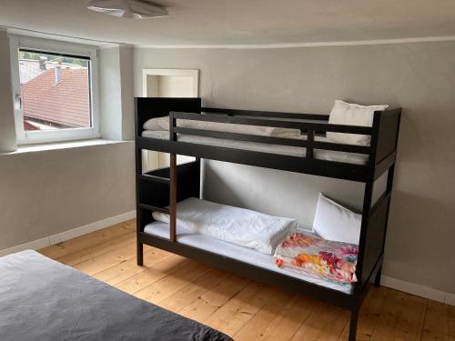 two bunk beds in a room with a bed at Familienfreundliches Haus mit eingezäuntem Garten in Biberwier