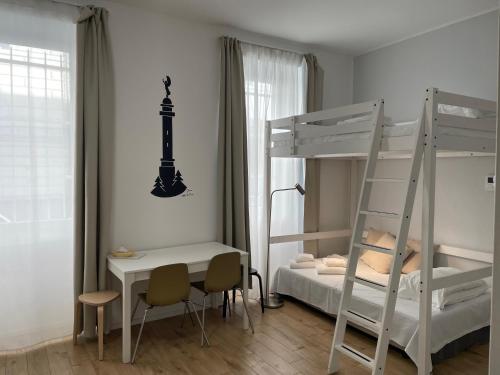 a bedroom with two bunk beds and a desk at Casanova Trieste Centrale in Trieste