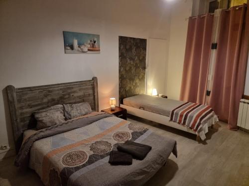 a bedroom with two beds and two candles on a table at Gîte pour professionnels en déplacement - CENTRE VILLE - Parking gratuit in Bellac