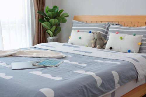 a bed with a blue comforter with a book on it at 2000sq ft 186平米Luxury Residence in IMAGO Mall, KK in Kota Kinabalu