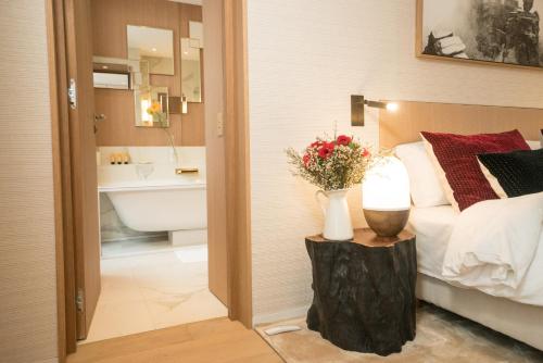 a bedroom with a bed and a bathroom with a sink at Superbe Penthouse 3 Chambres Hammam Terrasse in Paris