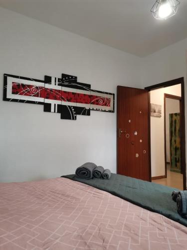a bedroom with a bed and a mirror and a door at Trapani Emotions apartment in Valderice